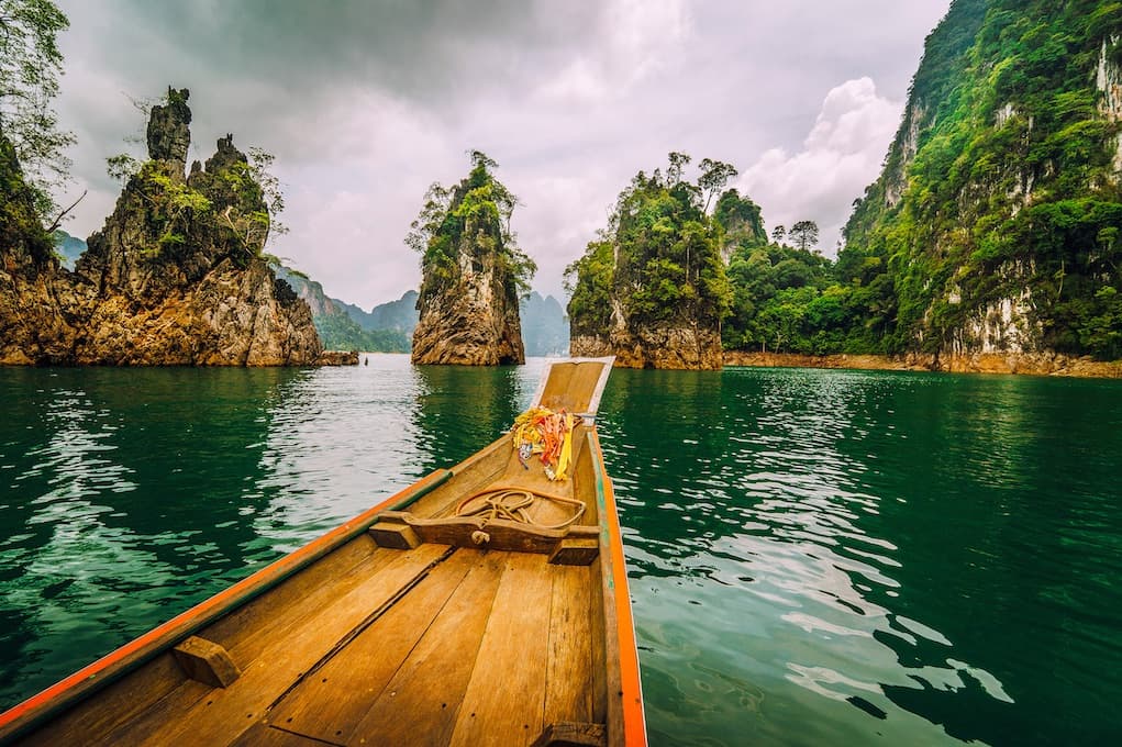 Longtail boat navigating karst peaks