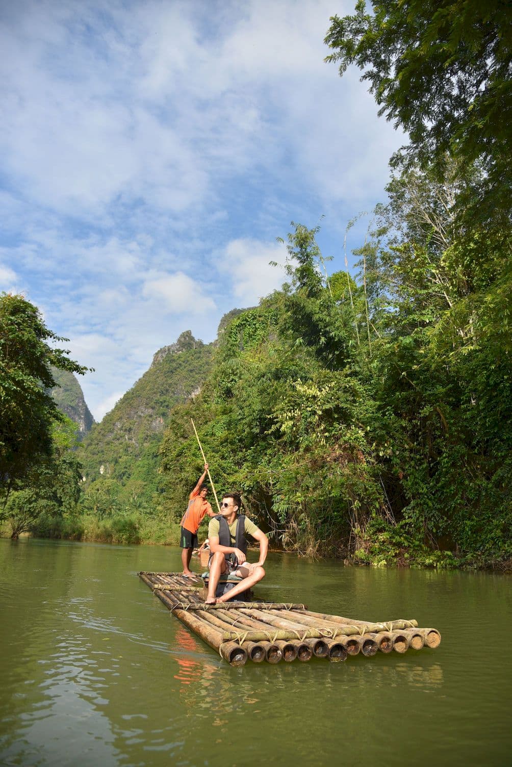 Riding a bamboo raft down a quiet river