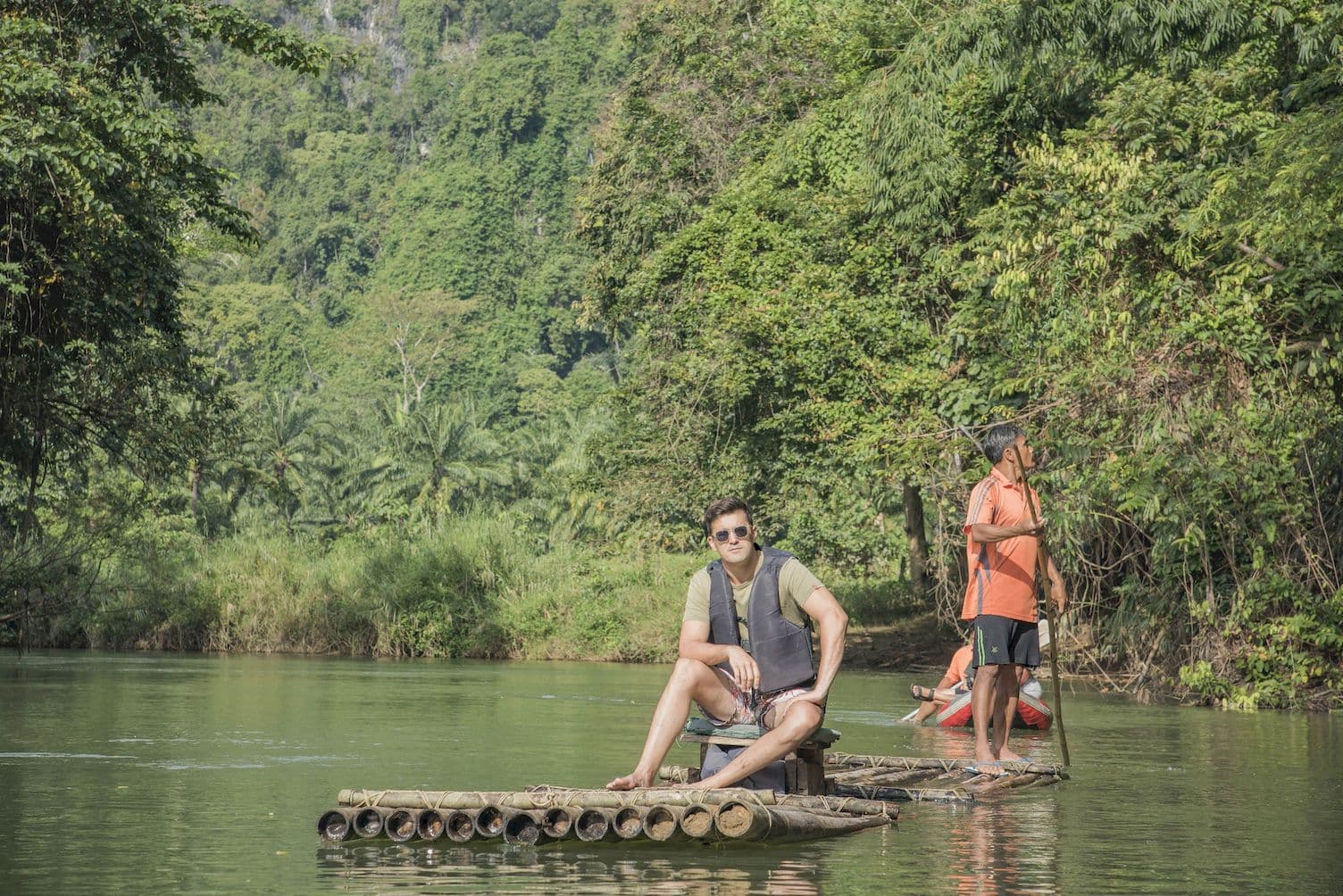 Riding a bamboo raft down a quiet river