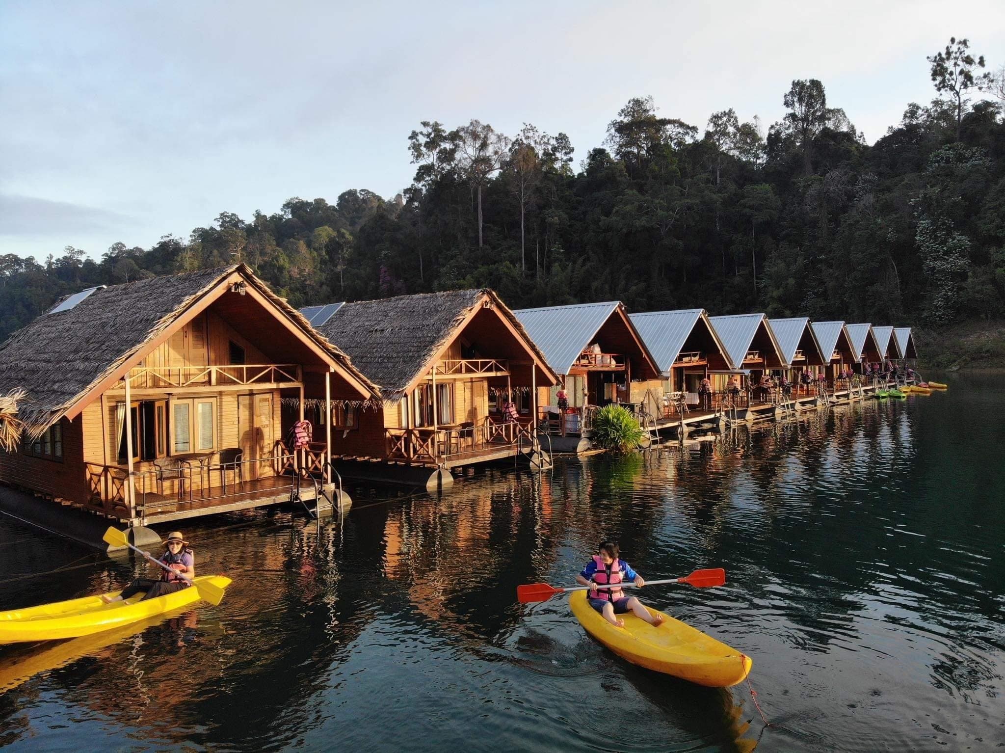 Bamboo raft houses on the lake at sunset