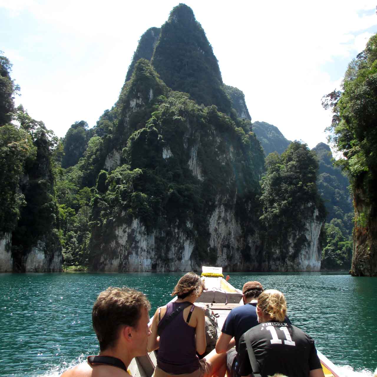 Karst mountains on Cheow Larn lake with long tail boat