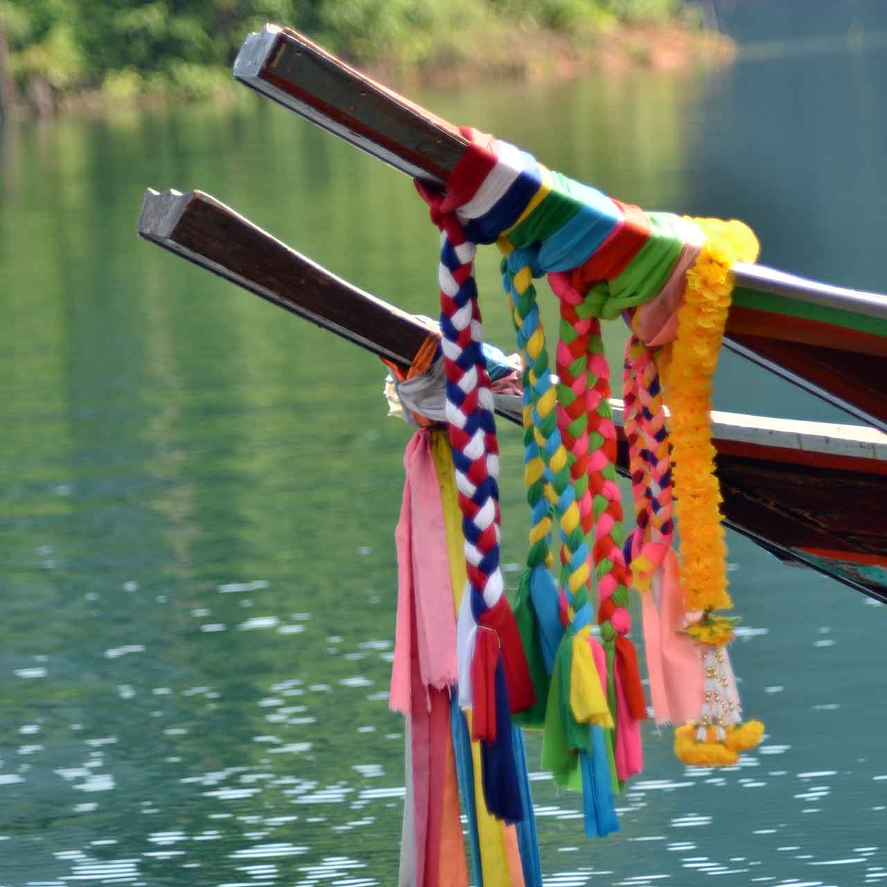 Flowers tied aroudn the bow of a longtial boat