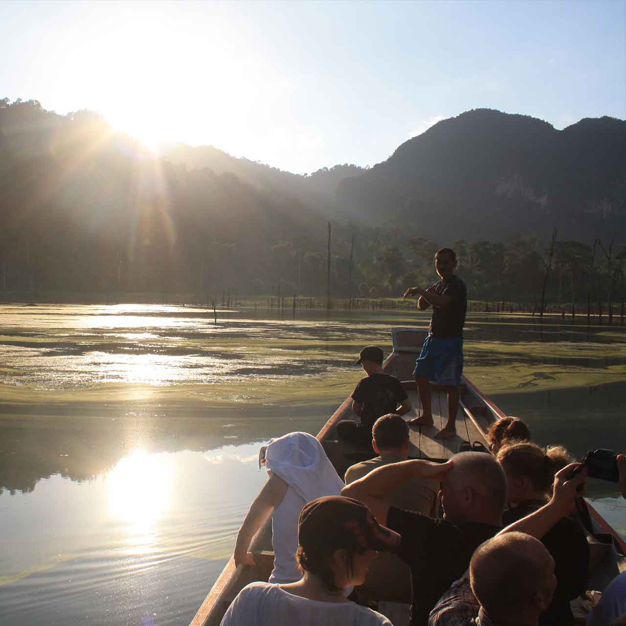 Riding a longtial boat on Cheow Larn lake at sunset