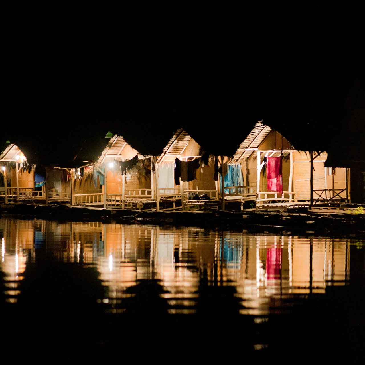 Bamboo huts on Cheow Larn lake at night
