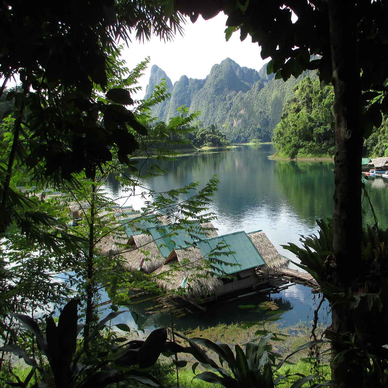 Lookng through the trees at bamboo huts on Cheow Larn lake
