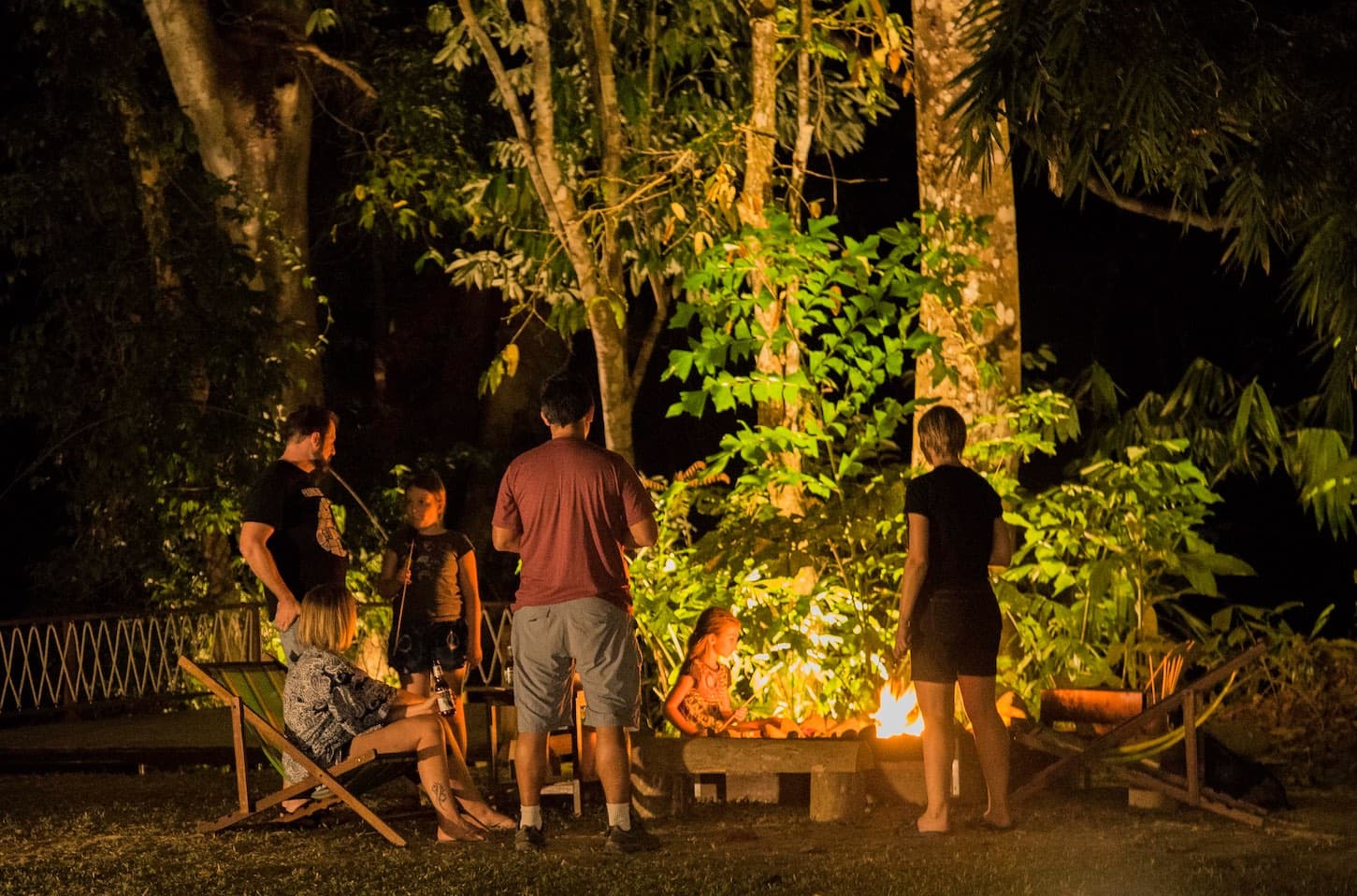 Family cooking in the jungle by a campfire